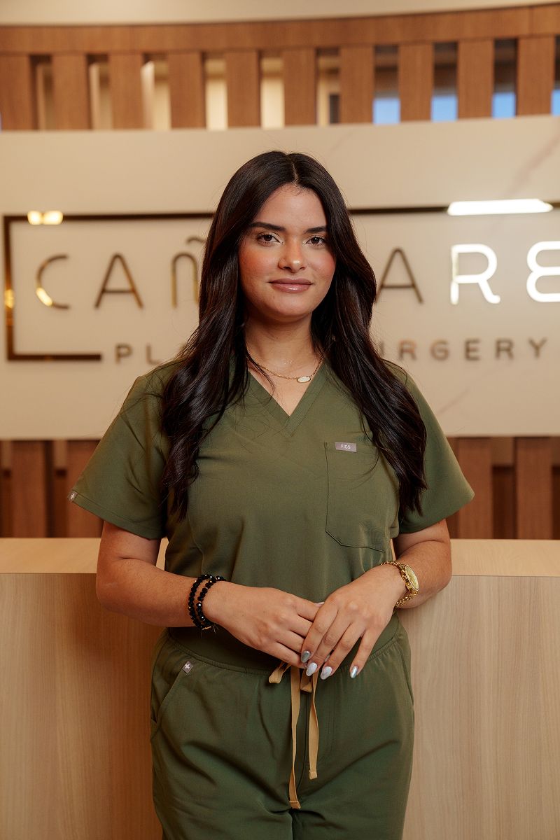 Person wearing scrubs at a medical office.