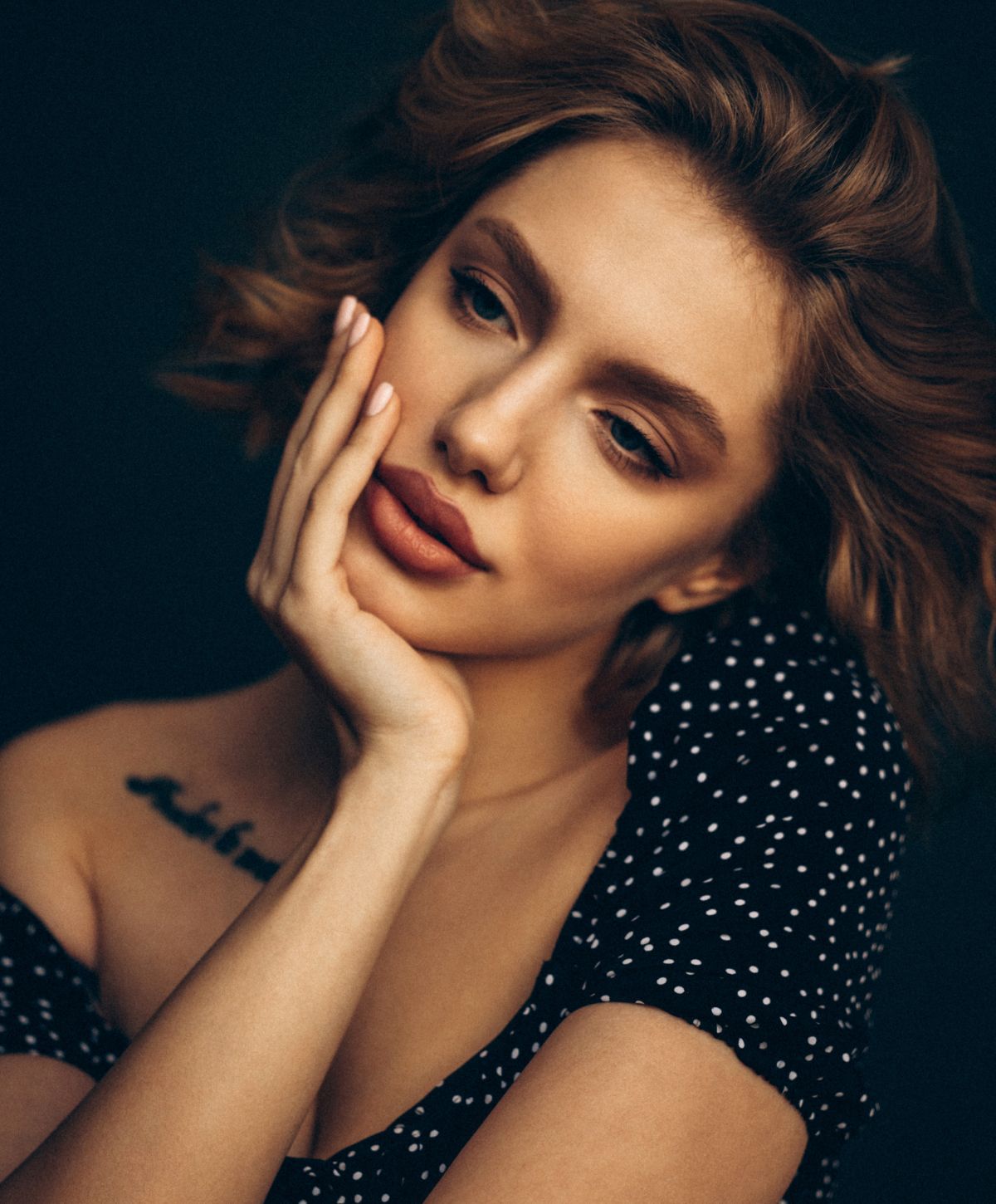 Portrait of a woman with thoughtful expression.