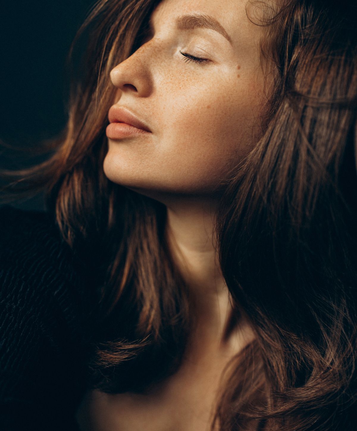 Woman with closed eyes and flowing hair.