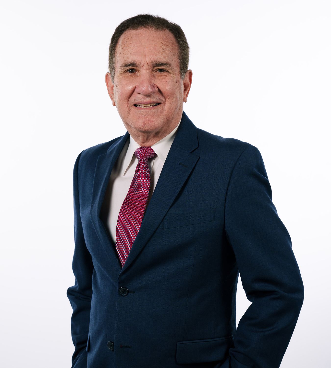 Smiling man in a suit against white background.