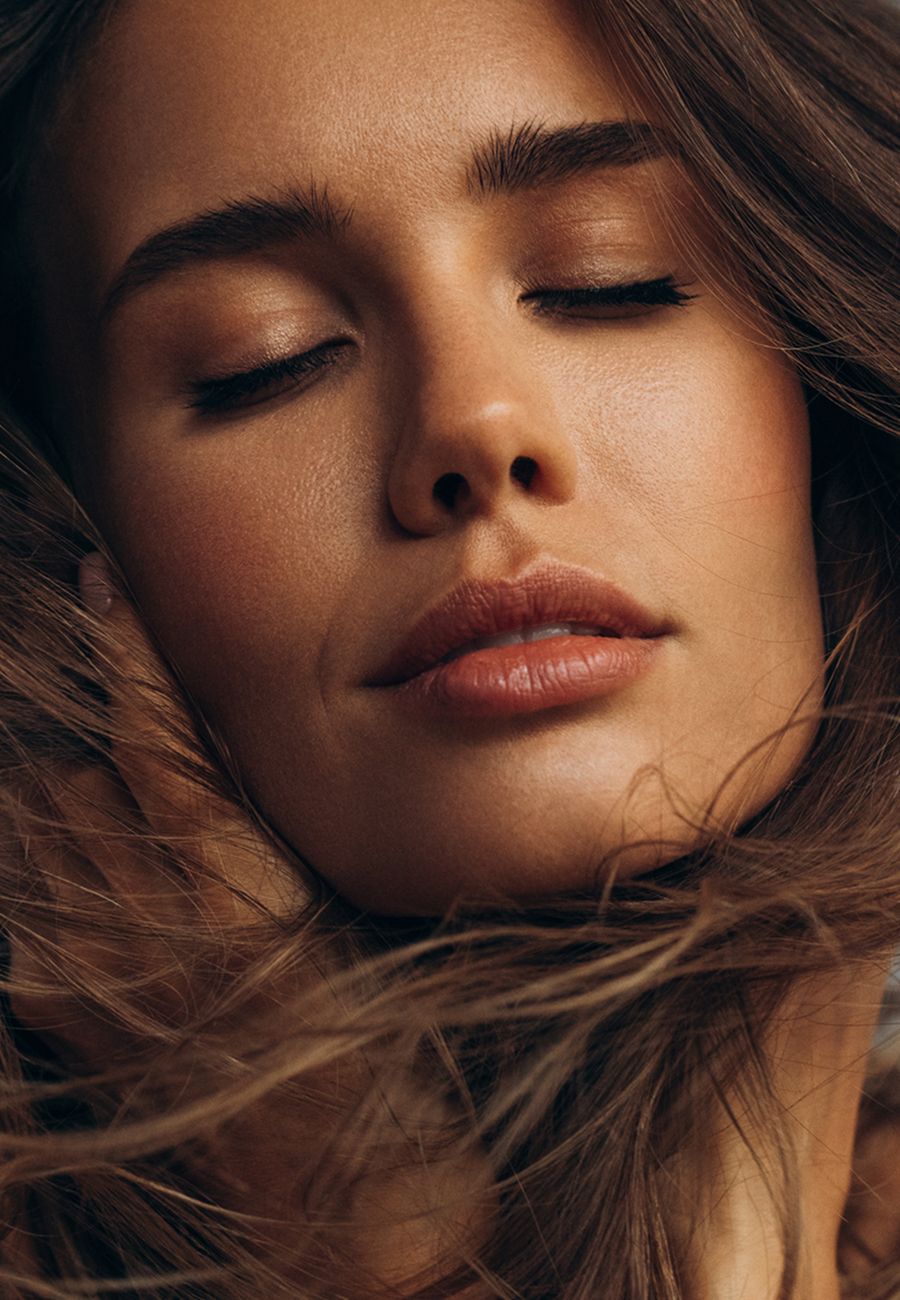 Model posing elegantly against a neutral background.