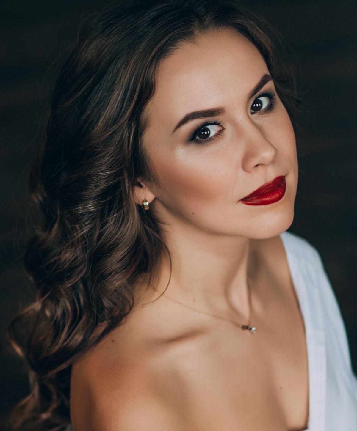 Woman with long hair and red lipstick.