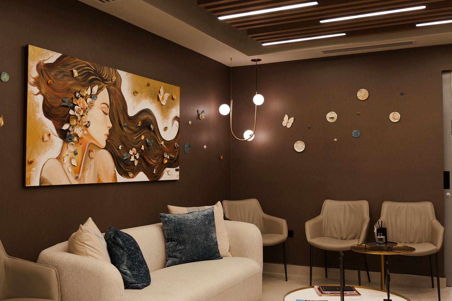 Modern lounge with artistic wall decor and lighting.