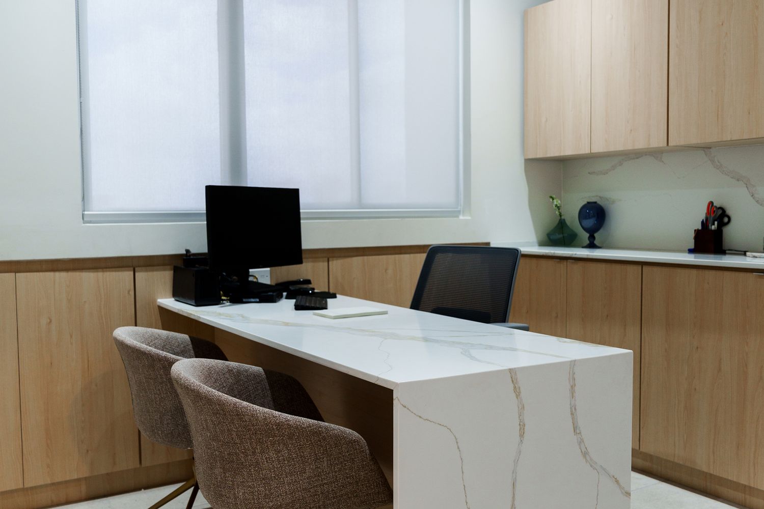 Modern office interior with desk and computer.