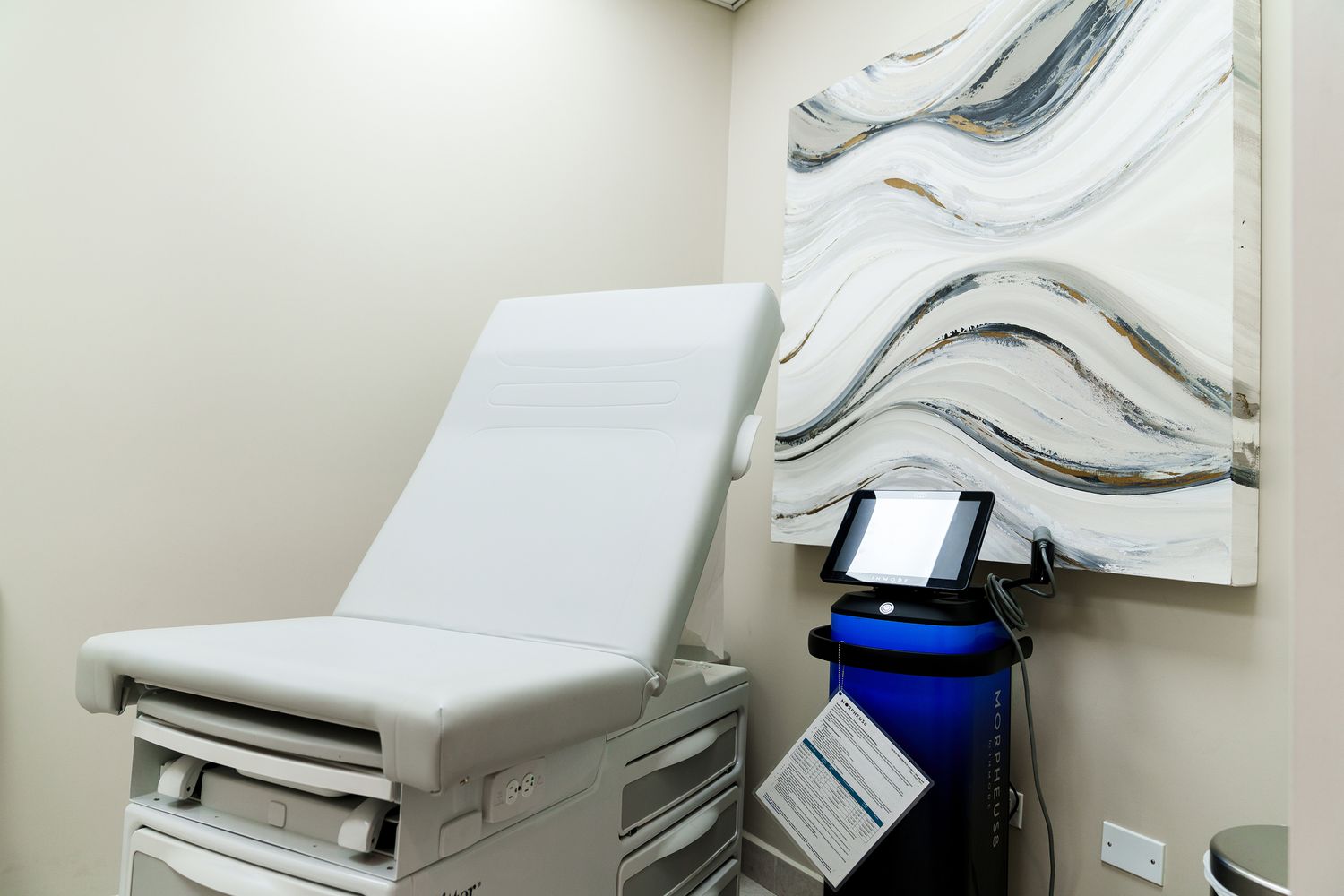 Medical examination room with equipment and decor.