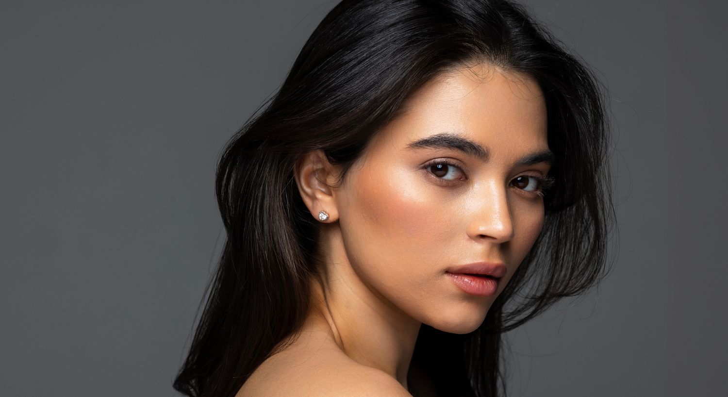 Portrait of woman with long dark hair.