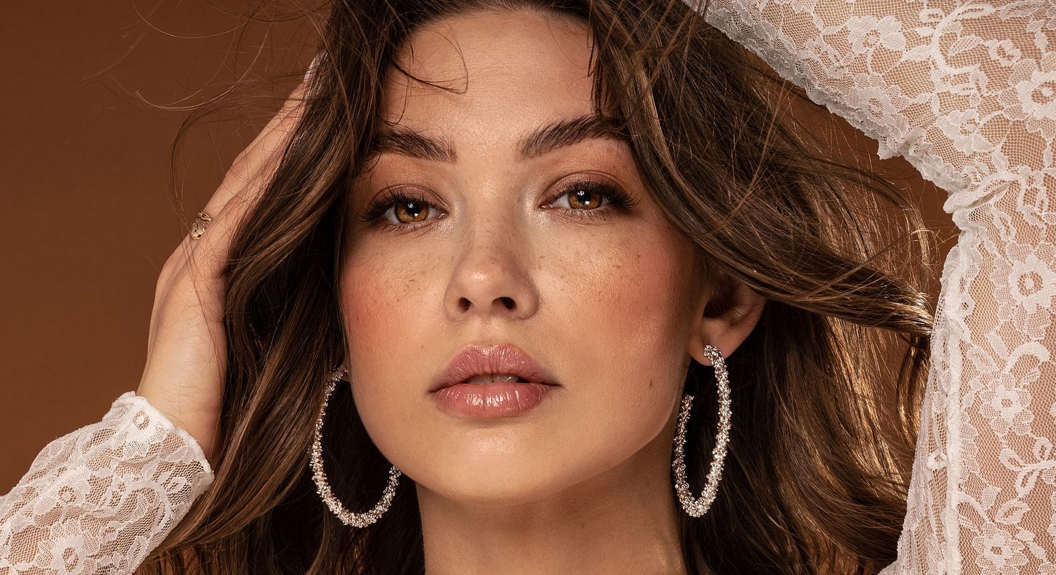Close-up of woman with stylish earrings and makeup.