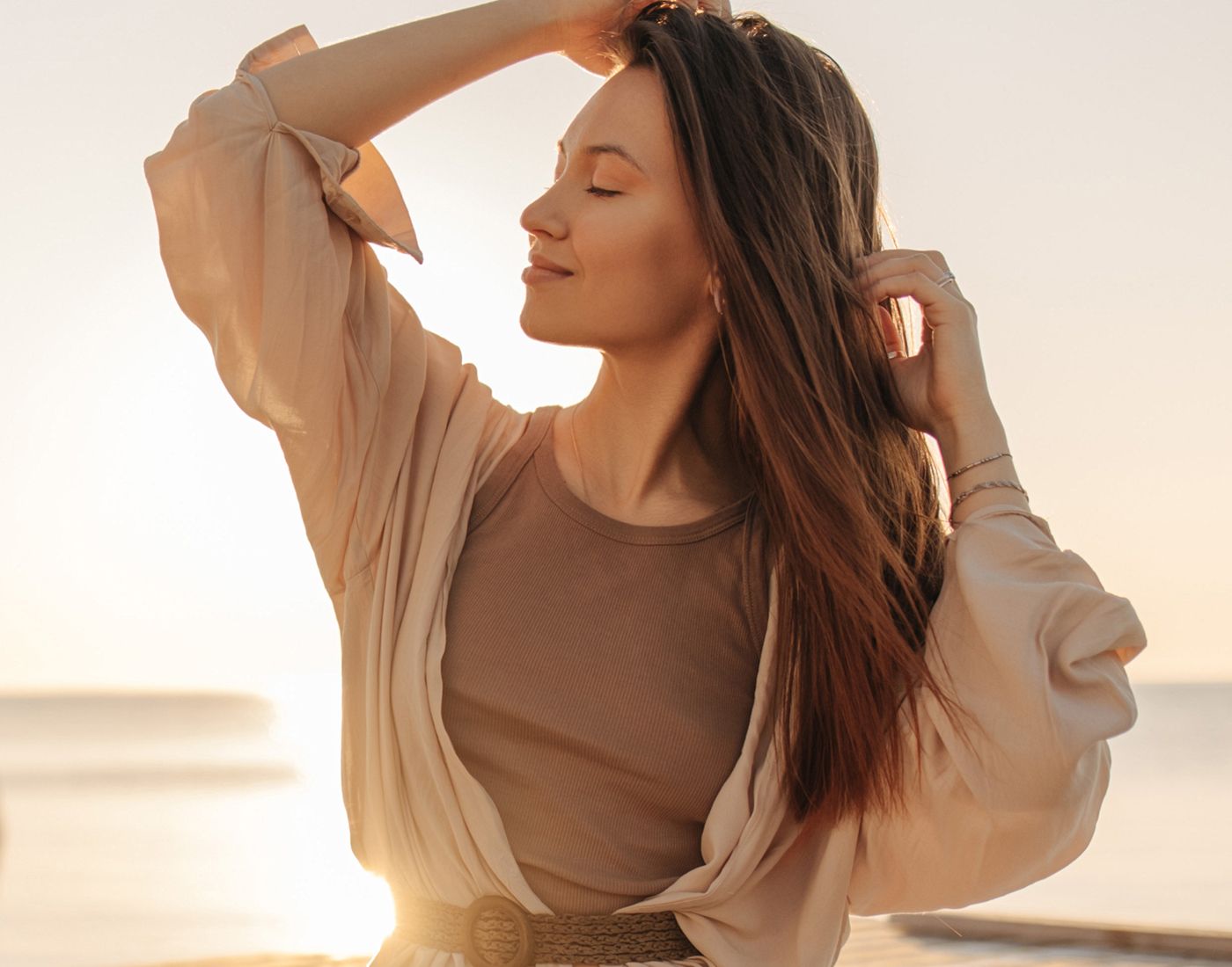 Woman enjoying sunset by the beach.