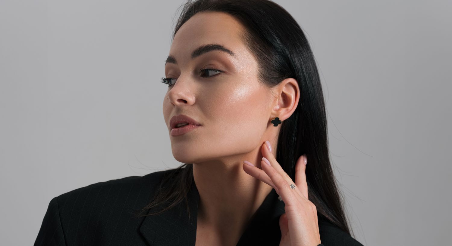 Woman wearing earrings, posing stylishly.