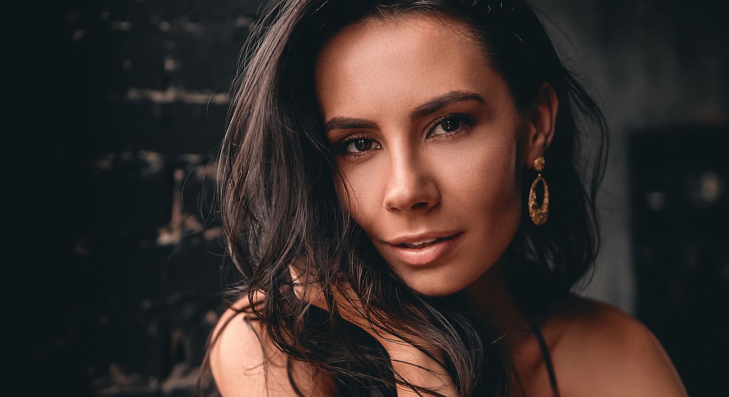 Portrait of a woman with long, dark hair.