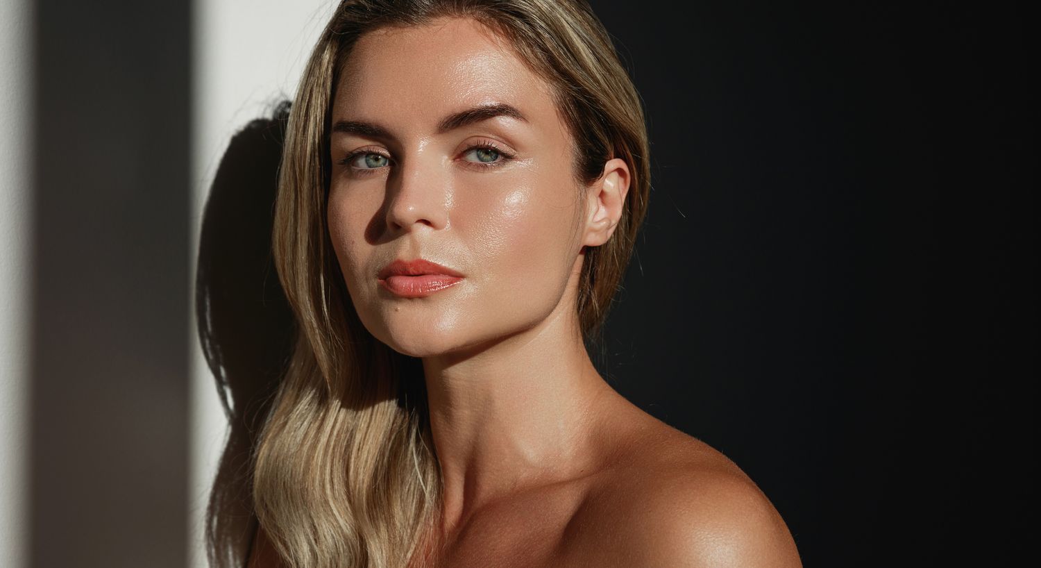 Close-up of woman with elegant expression and makeup.